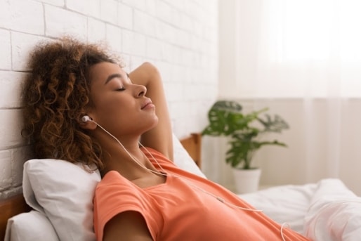 African-american woman relaxing and listening to music