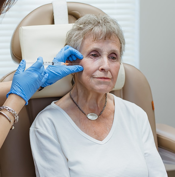 Sculptra-4 Physician treating patient's cheek with Sculptra Aesthetic