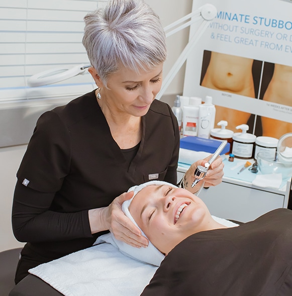 Patient and provider are laughing during an oxygen facial