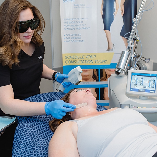 Esthetician putting gel on a woman's neck