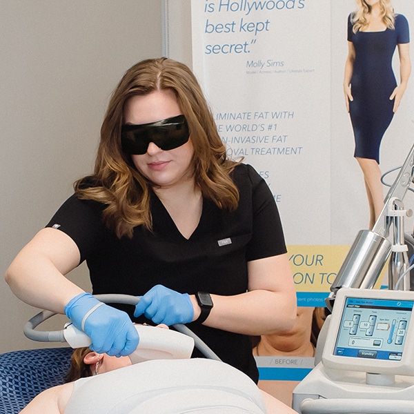 SkinTyte3 esthetician treating woman's neck with skintyte