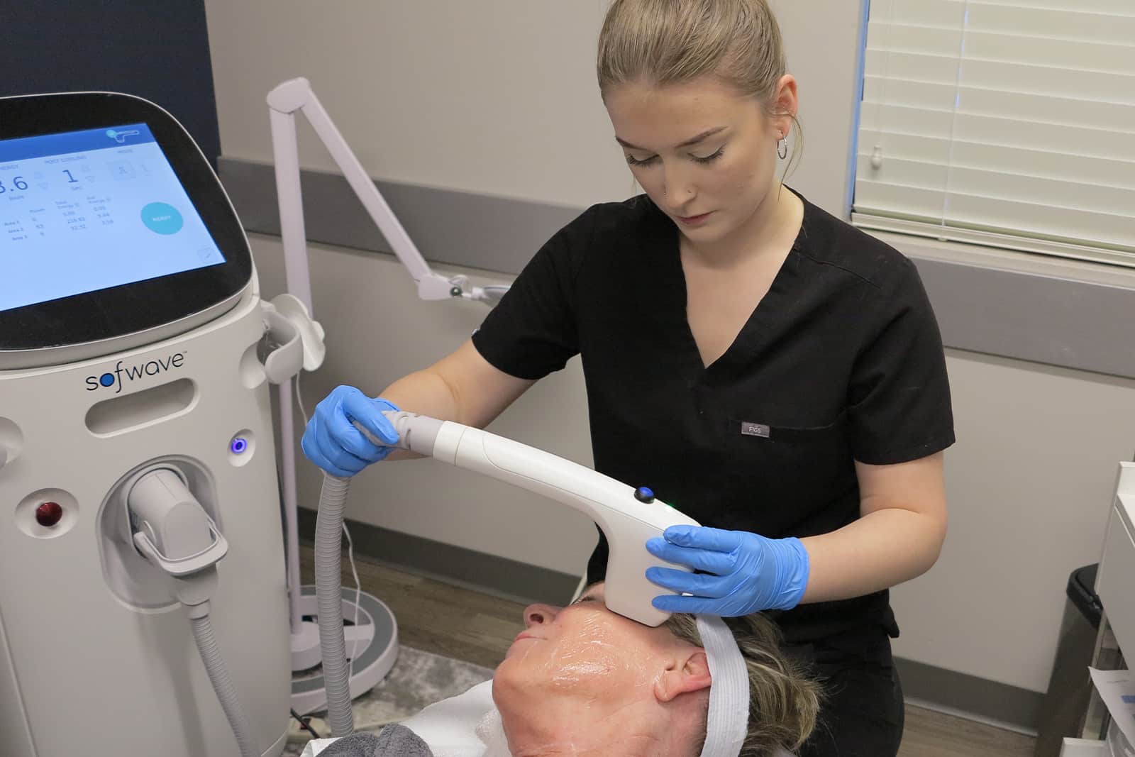 Master Esthetician giving patient noninvasive face lift with sofwave