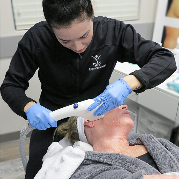 Master Esthetician tightening a patient's jowls with Sofwave