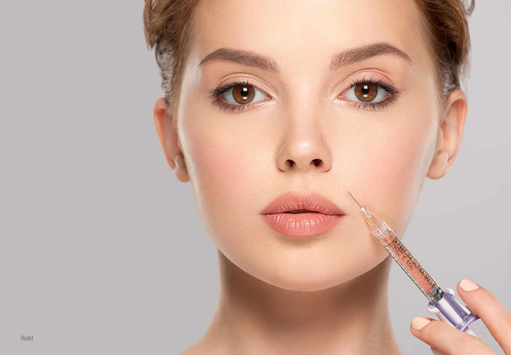 Female with a botox injection in her hand 