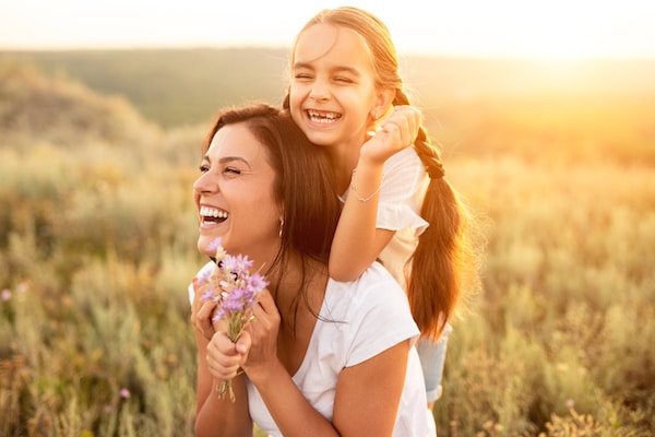 Happy woman laughs with a cheerful child