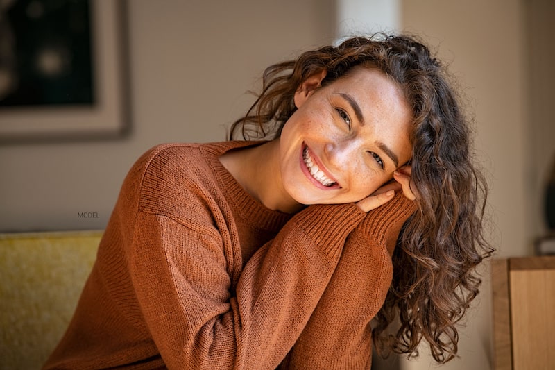 Young woman smiling on a couch